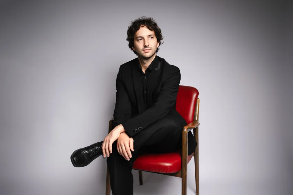 Rodolfo Focarelli Portrait sitting on a red chair